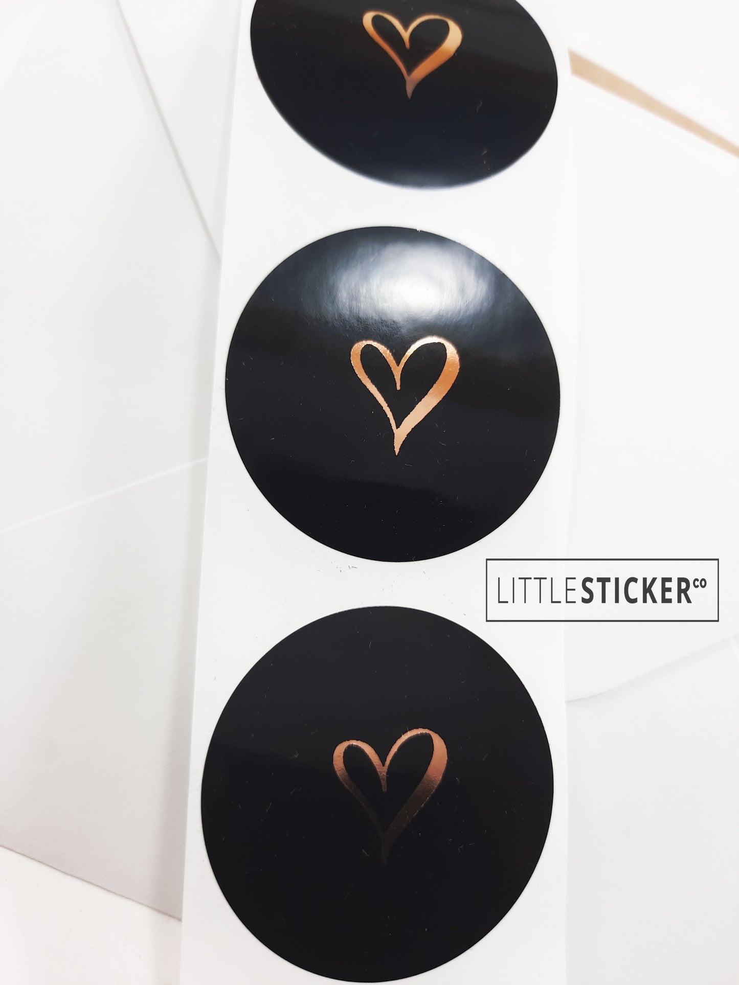 Heart stickers hand-drawn love heart. Round gloss black stickers with rose-gold foil. Choice of small, medium or large heart