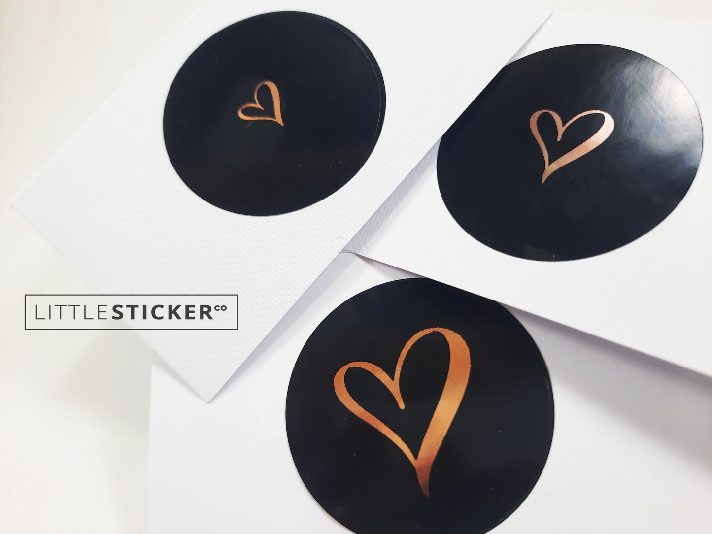 Heart stickers hand-drawn love heart. Round gloss black stickers with rose-gold foil. Choice of small, medium or large heart