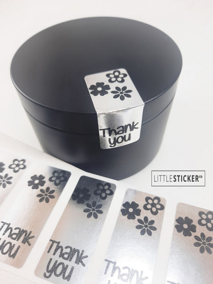 Thank you stickers. 50x20mm rectangle Silver stickers with black ''Thank you'' and cute daisy flowers