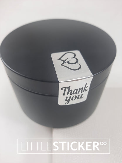 Thank you stickers. 50x20mm rectangle Silver stickers with black ''Thank you'' and twin hearts