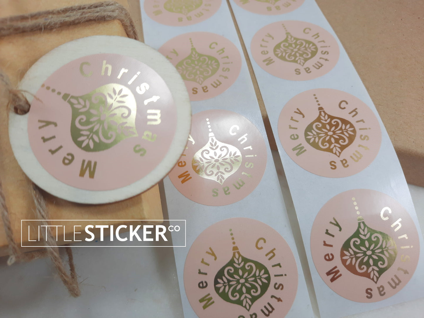 Merry Christmas stickers. 40mm round pink buff gloss stickers with Gold Foil ''Merry Christmas'' and Christmas bauble.