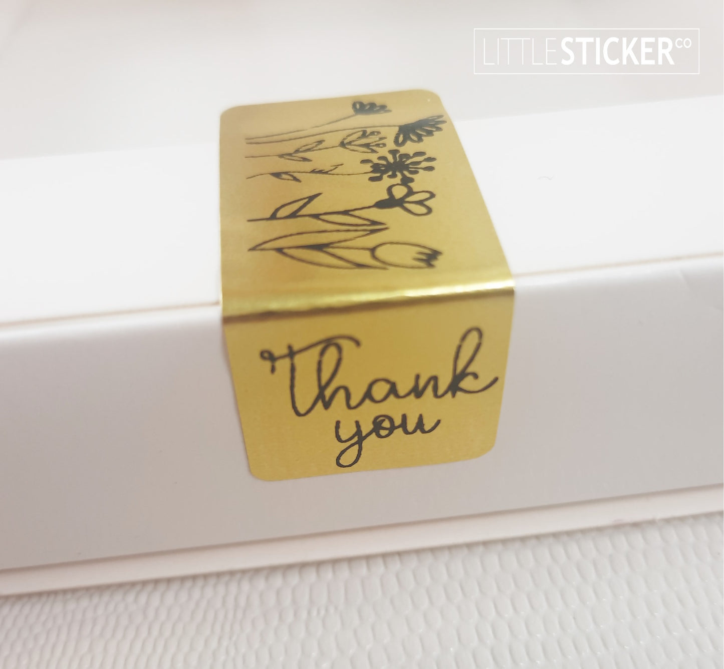 Thank you stickers. 50x20mm rectangle Gold stickers with black ''Thank you'' and sweet hand drawn style flowers