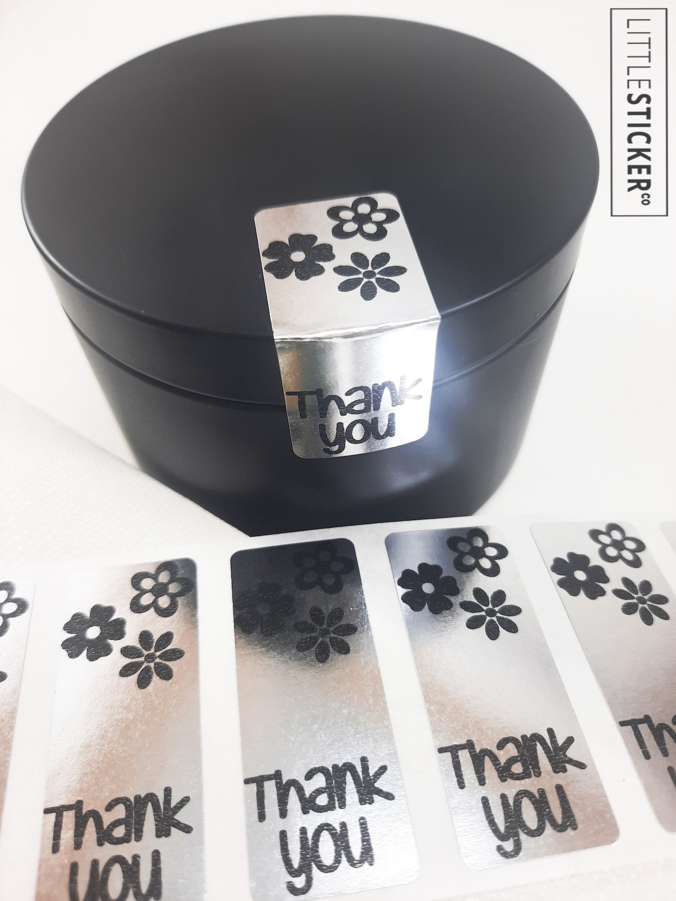 Thank you stickers. 50x20mm rectangle Silver stickers with black ''Thank you'' and cute daisy flowers