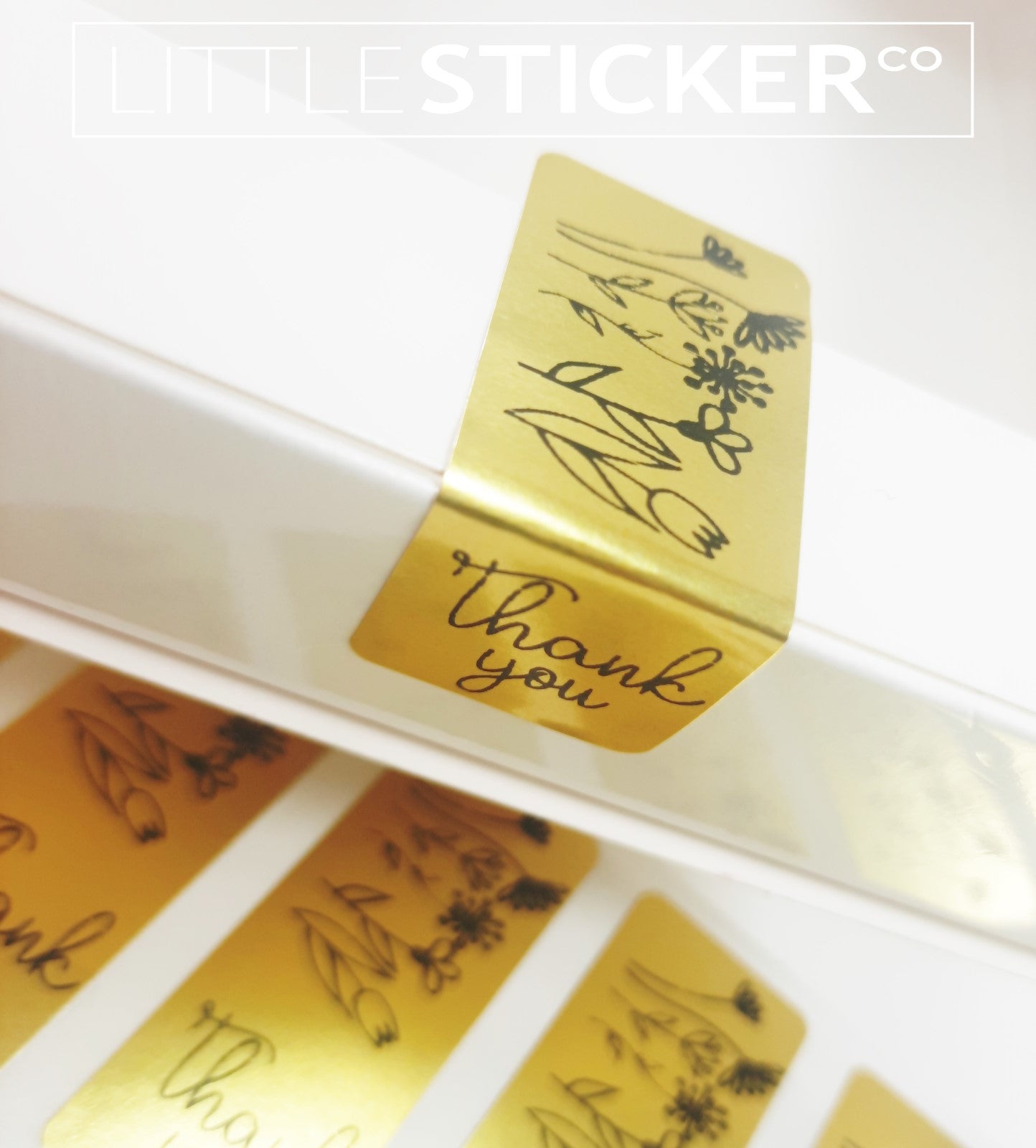 Thank you stickers. 50x20mm rectangle Gold stickers with black ''Thank you'' and sweet hand drawn style flowers