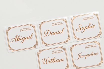 Set of personalized name stickers with orange text on a white background