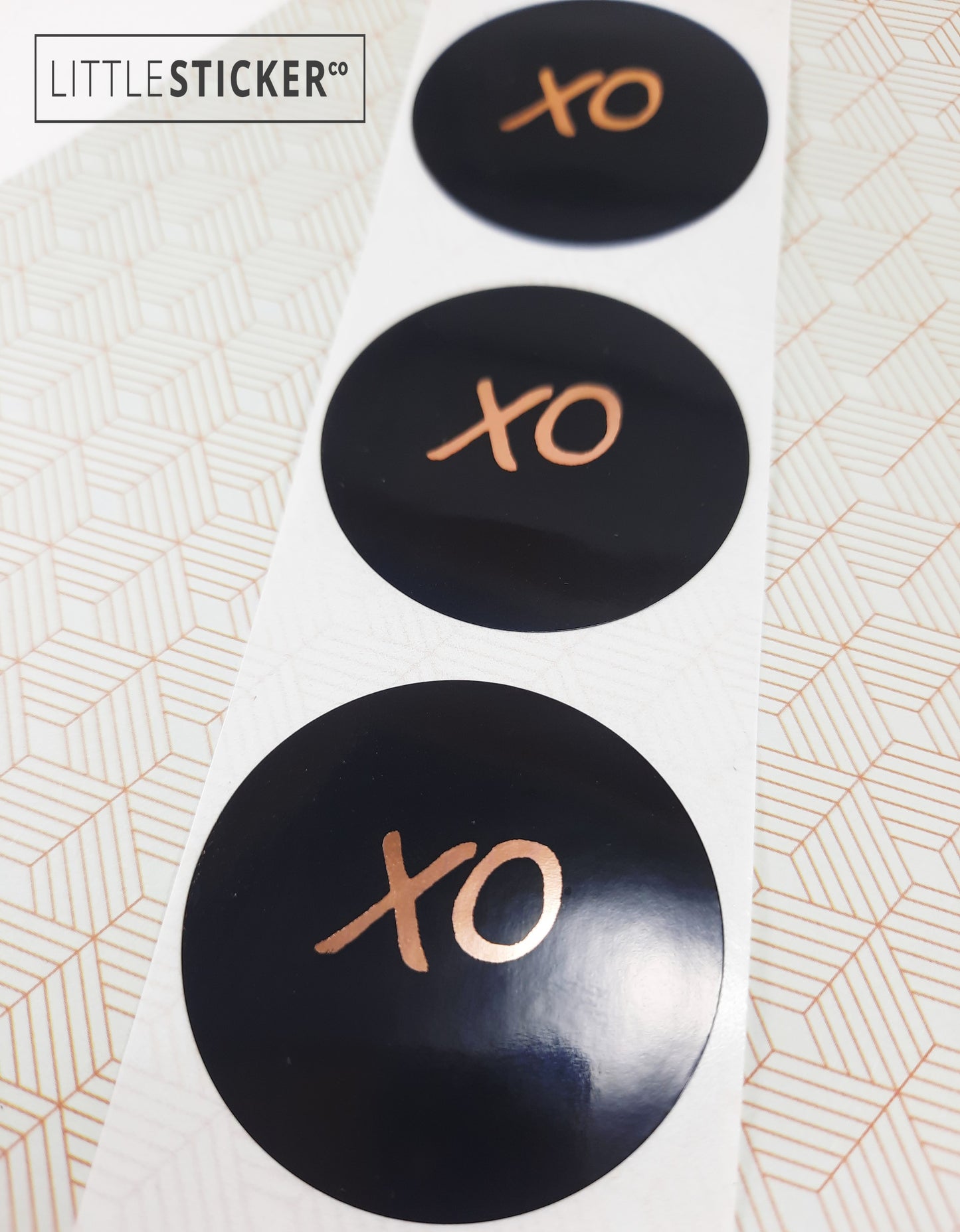 XO stickers  hand-drawn. Round gloss black stickers with rose-gold foil hugs and kisses symbol. Choice of small, medium or large print  XO