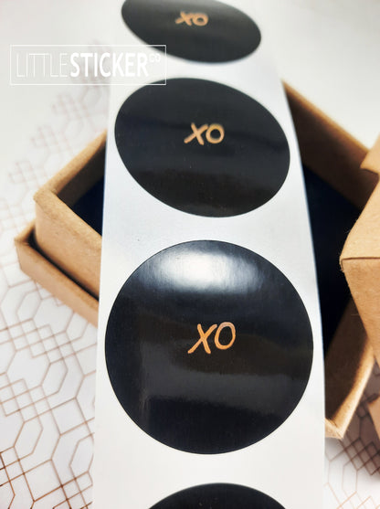 XO stickers  hand-drawn. Round gloss black stickers with rose-gold foil hugs and kisses symbol. Choice of small, medium or large print  XO