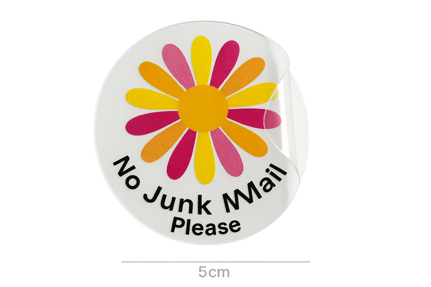 a photograph of a clear round sticker that is 5cm across. The sticker is half peeled off it's white paper backing.  The sticker has a bold daisy flower printed on it in multiple colours, with the text ''No Junk Mail Please''. The sticker is clear.