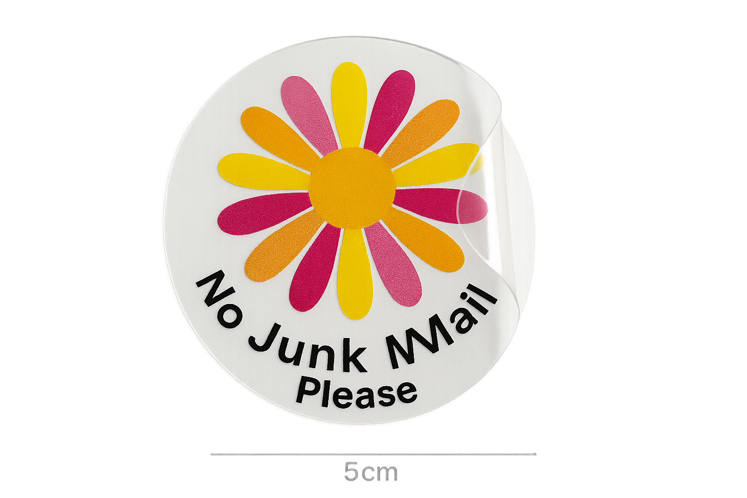 a photograph of a clear round sticker that is 5cm across. The sticker is half peeled off it's white paper backing.  The sticker has a bold daisy flower printed on it in multiple colours, with the text ''No Junk Mail Please''. The sticker is clear.