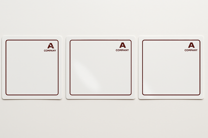 A row of glossy white stickers measuring 7cm wide and 6cm tall. The are facing in a landscape direction. Each sticker is printed with a dark red minimalist border. Each sticker has a small company logo in the top right corner in the same dark red colour